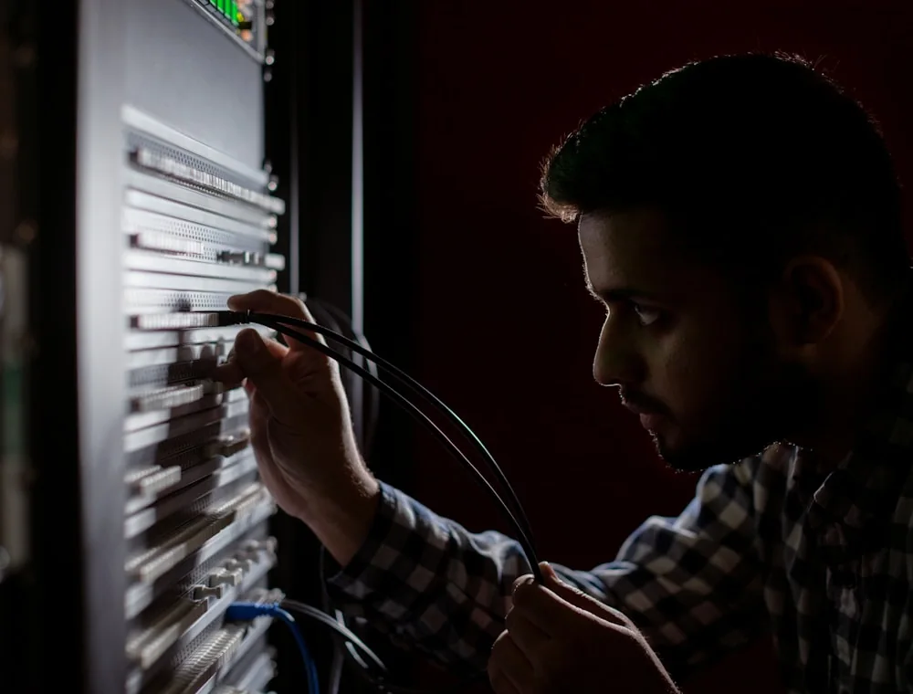 Technician configuring connectivity in an IT rack